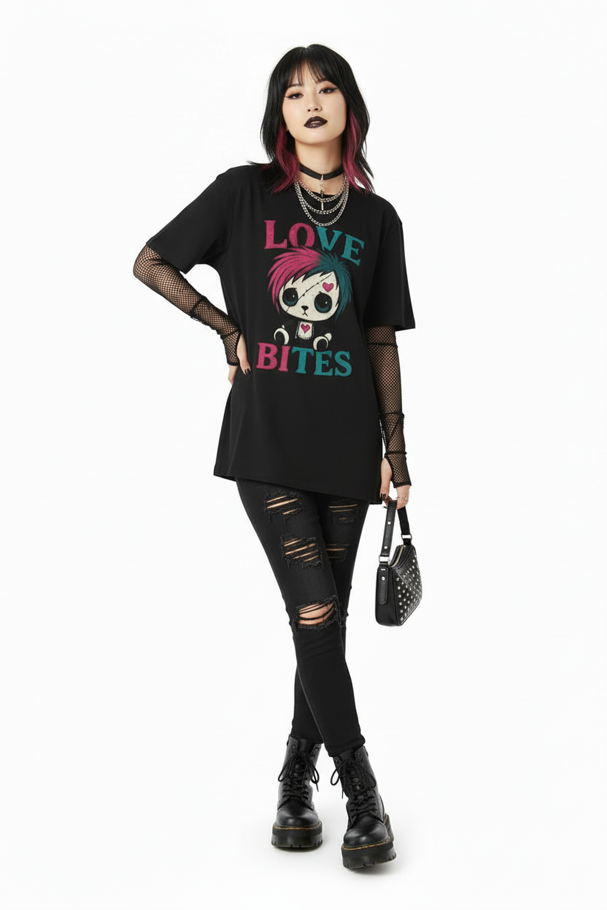 Person wearing a black t-shirt with a graphic design and text, black ripped jeans, and black boots on a white background.