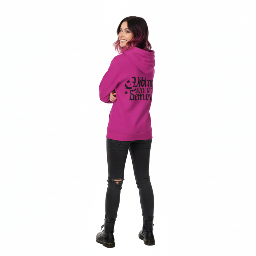 Person wearing a pink hoodie with text, standing against a white background