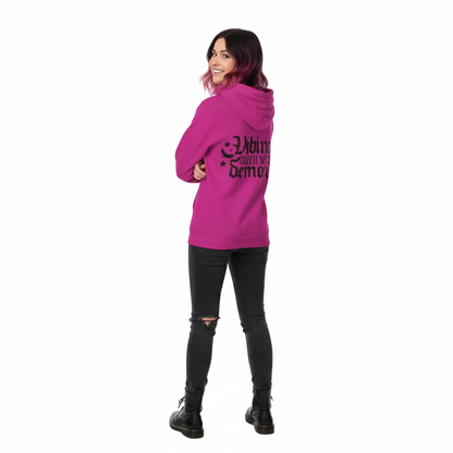 Person wearing a pink hoodie with text, standing against a white background