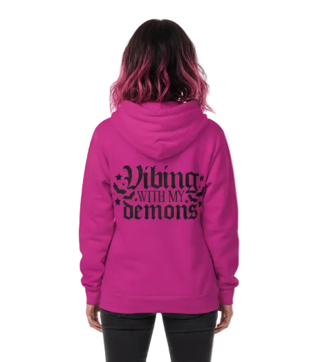 Person wearing a pink hoodie with 'Living with my demons' text on the back, on a white background