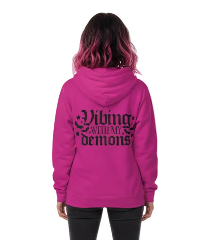Person wearing a pink hoodie with 'Living with my demons' text on the back, on a white background