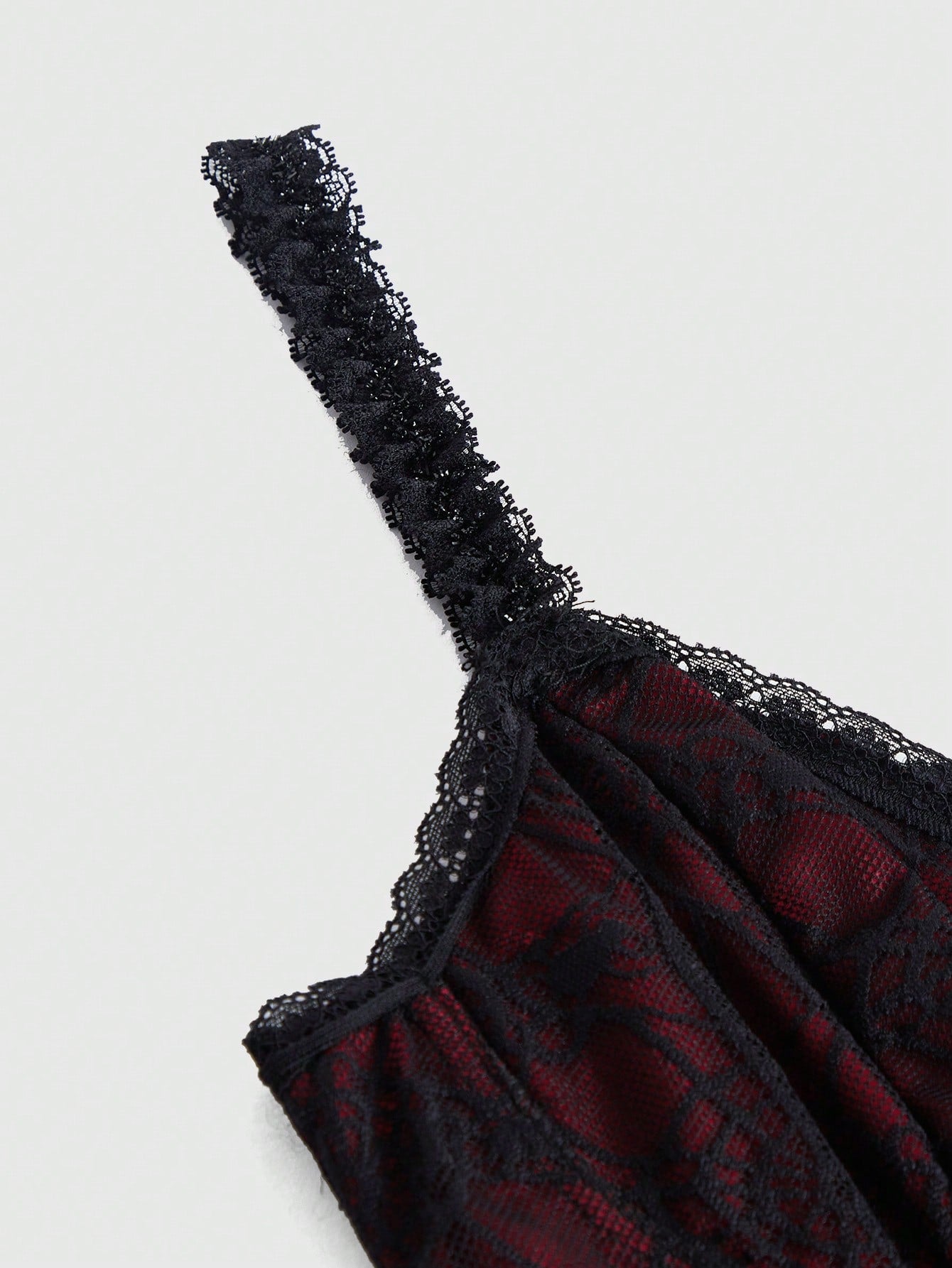 Close-up of Gothic Queen halter top lace detail showing delicate floral and web patterns"
"Side view of black lace halter top showing elegant neckline and back design"
"Gothic lace halter styled with high-waisted skirt for complete alternative fashion look"
