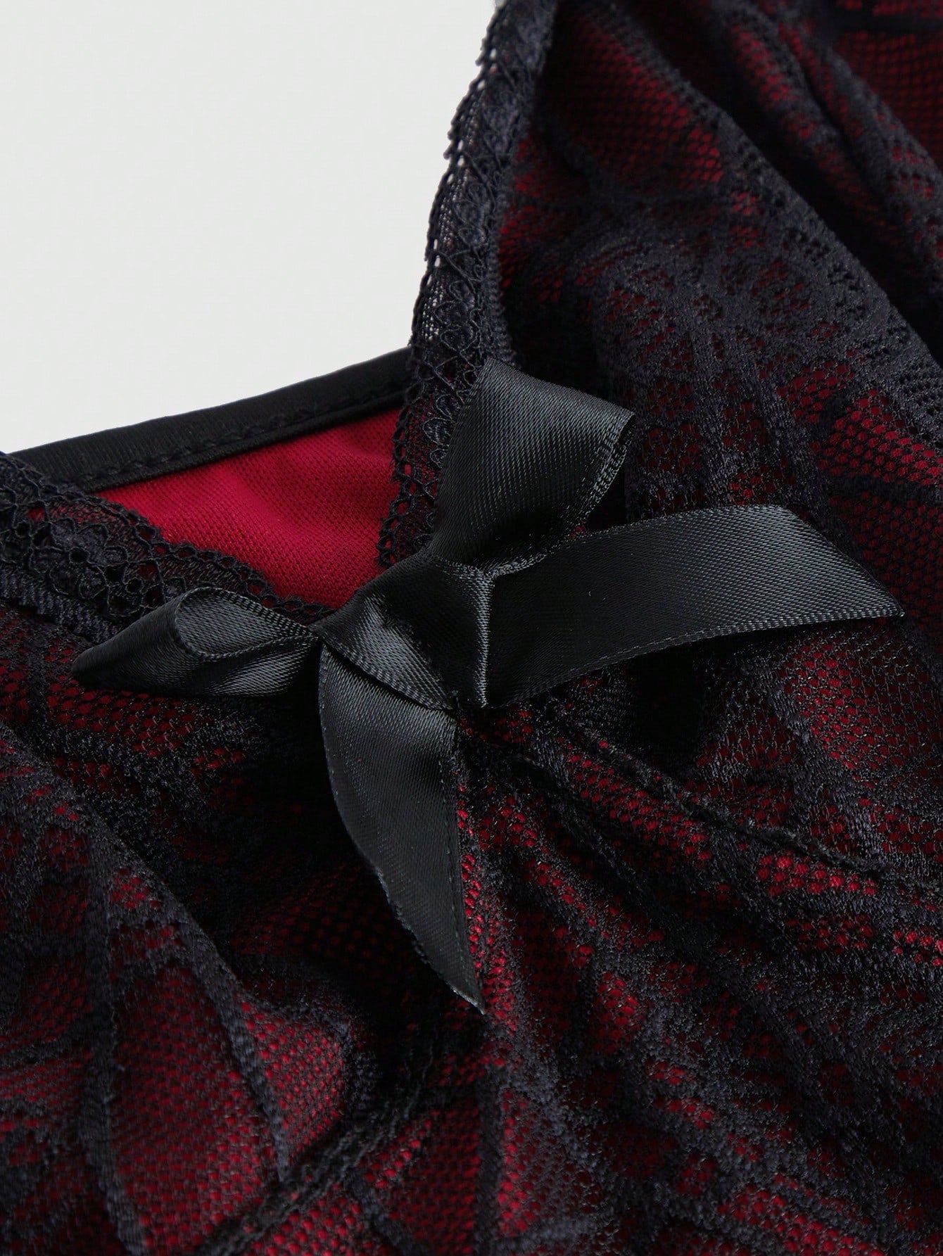 "Close-up of Gothic Queen halter top lace detail showing delicate floral and web patterns"
"Side view of black lace halter top showing elegant neckline and back design"
"Gothic lace halter styled with high-waisted skirt for complete alternative fashion look"

