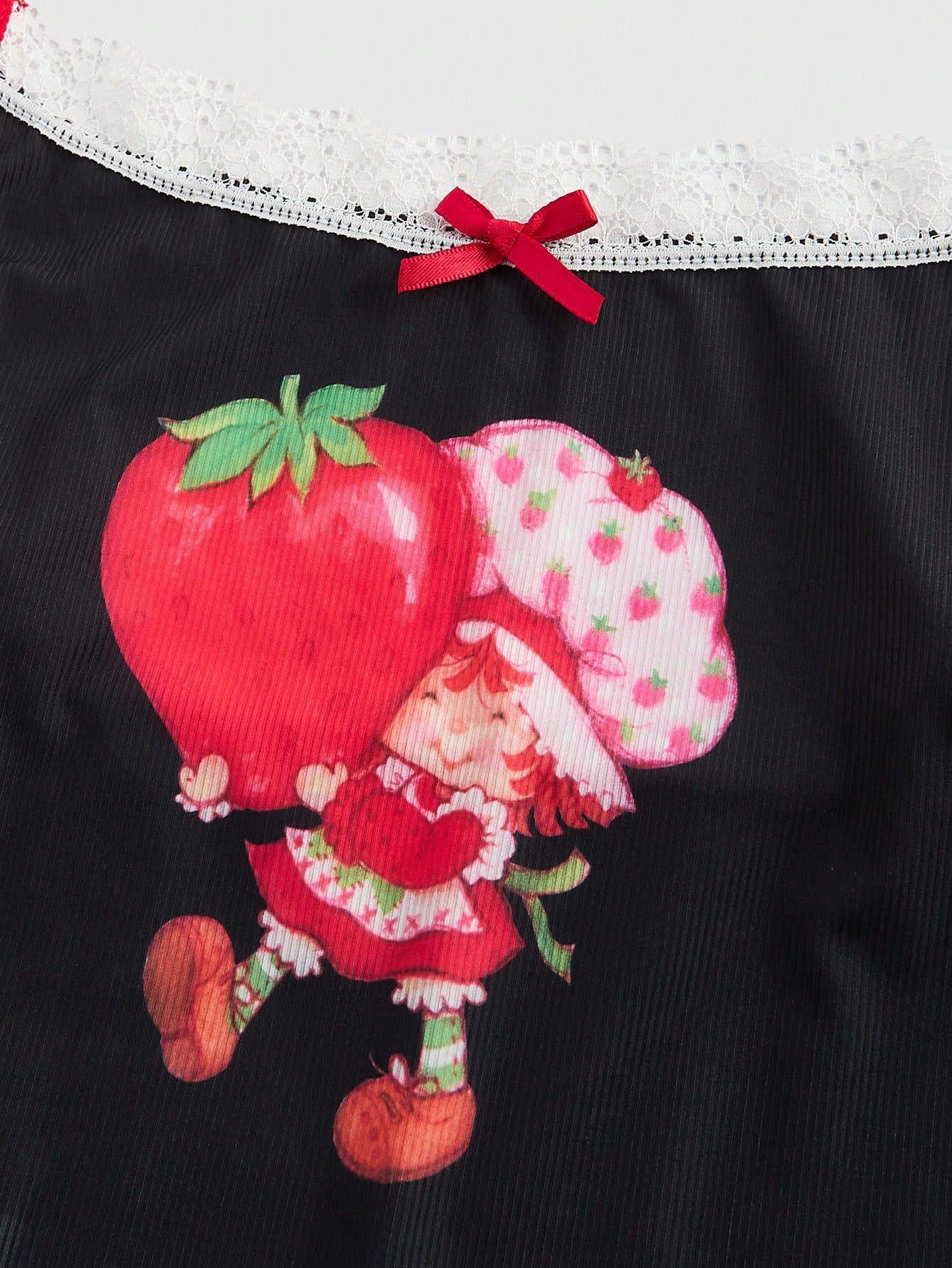 Loungewear top close-up showing detailed strawberry print pattern and fabric texture