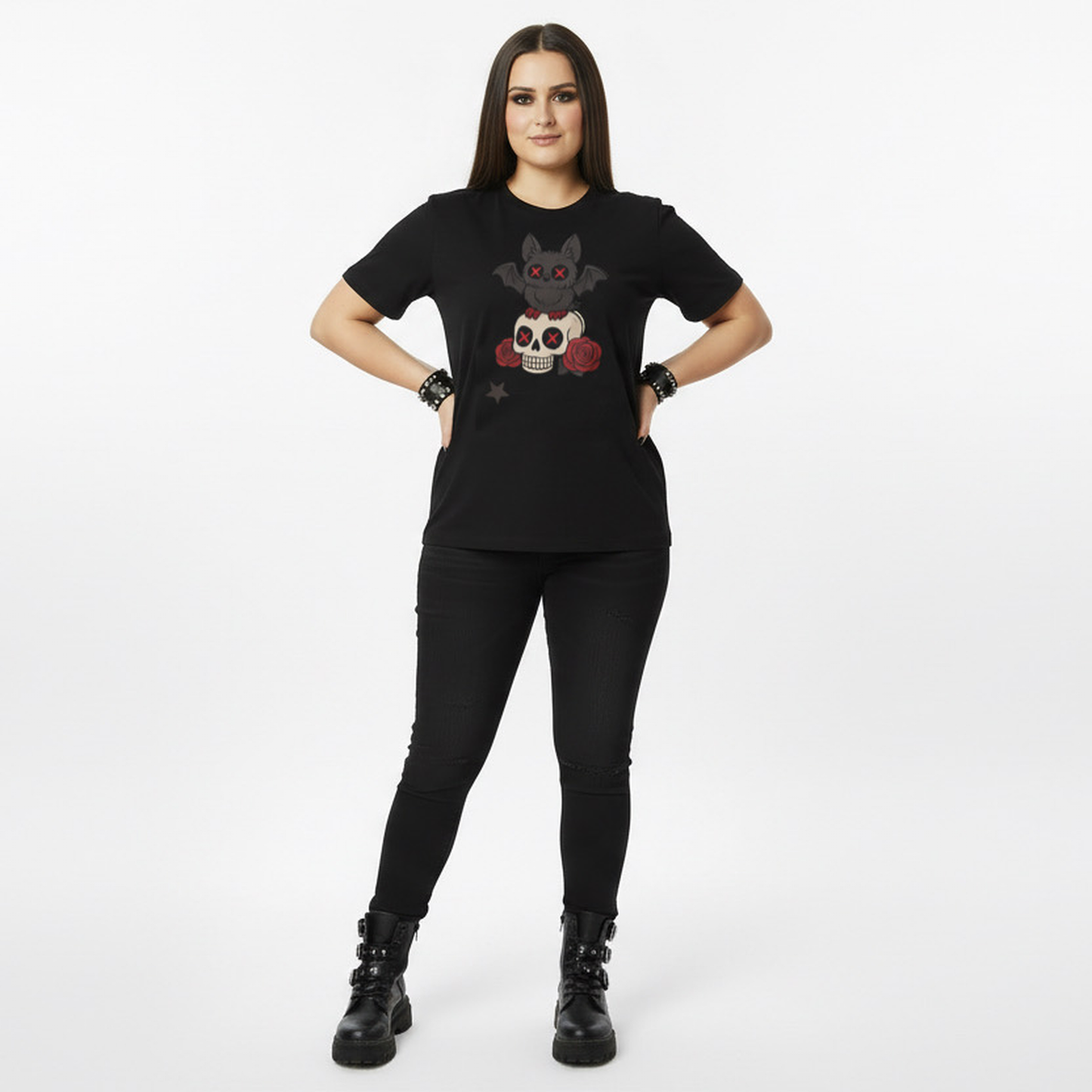 Person wearing a black t-shirt with a graphic goth bat design on a white background