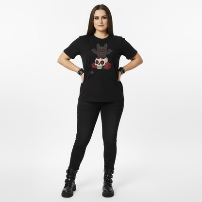 Person wearing a black t-shirt with a graphic goth bat design on a white background