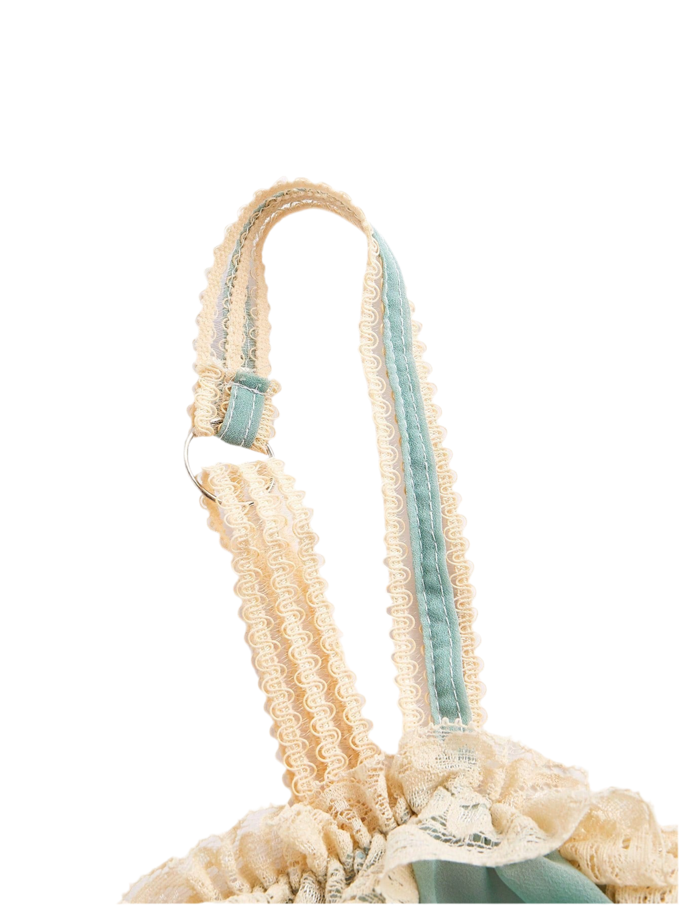 Close-up of loungewear top showing delicate lace and bowknot accents