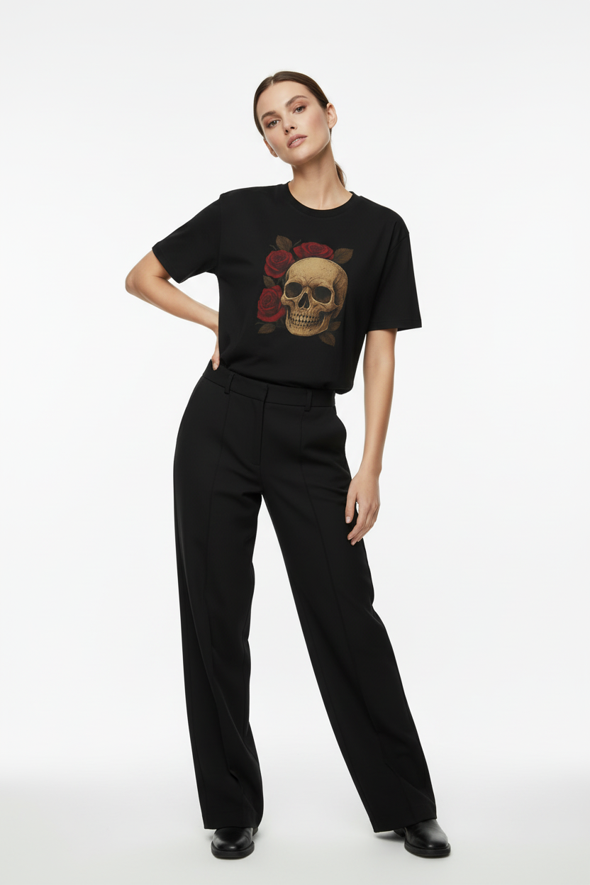 Person wearing a black t-shirt with a skull design and black pants on a white background