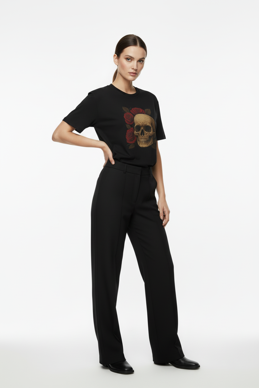 Person wearing a black t-shirt with a graphic design and black pants on a white background