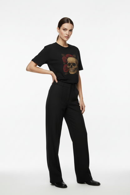 Person wearing a black t-shirt with a graphic design and black pants on a white background