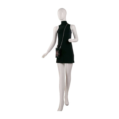 Mannequin wearing a black sleeveless dress with a small handbag on a white background