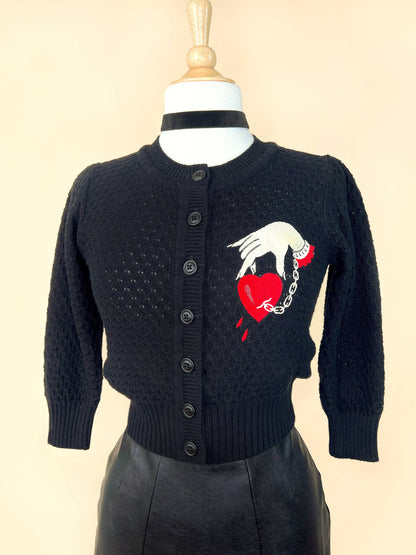 Black cropped cardigan with embroidered captive  heart and hand chain design
