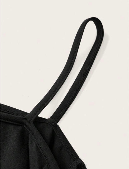 Off-shoulder black sweatshirt with white skull-and-tree design
