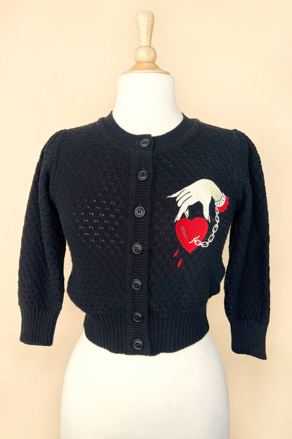 Black cropped cardigan with embroidered captive  heart and hand chain design