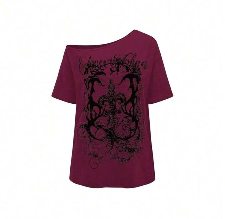 Deep wine off-shoulder tee with black distressed “Embrace the Chaos” print.