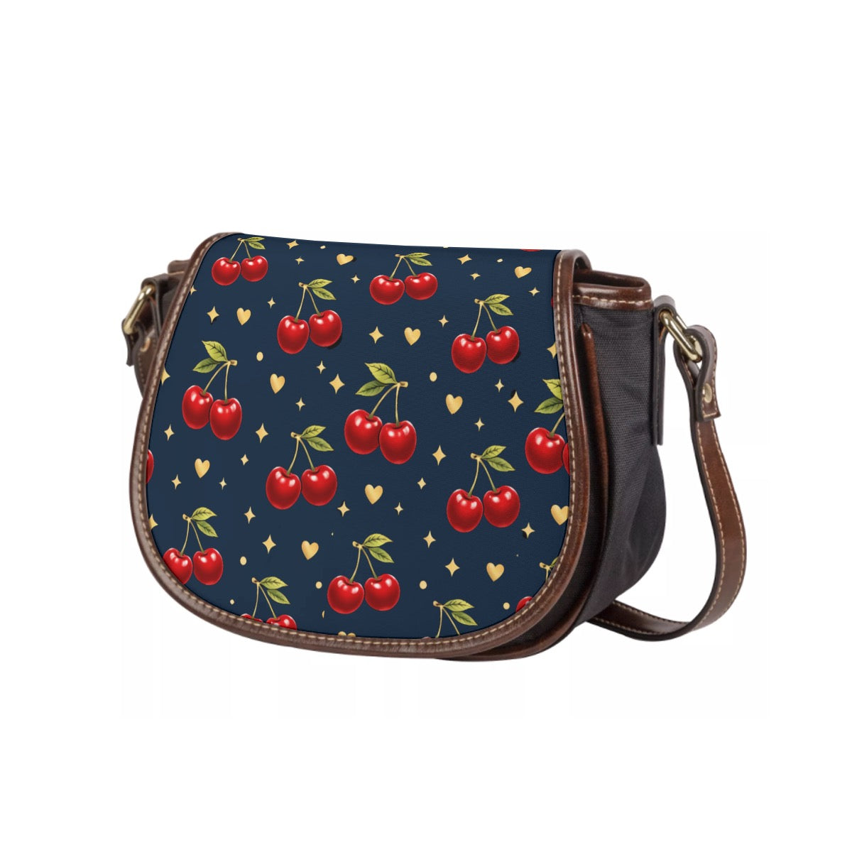 Cherry print saddle crossbody bag with navy flap, red cherries, gold heart and star accents, brown trim and adjustable strap.