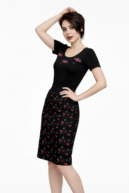 Woman wearing a black dress with floral embroidery on a white background