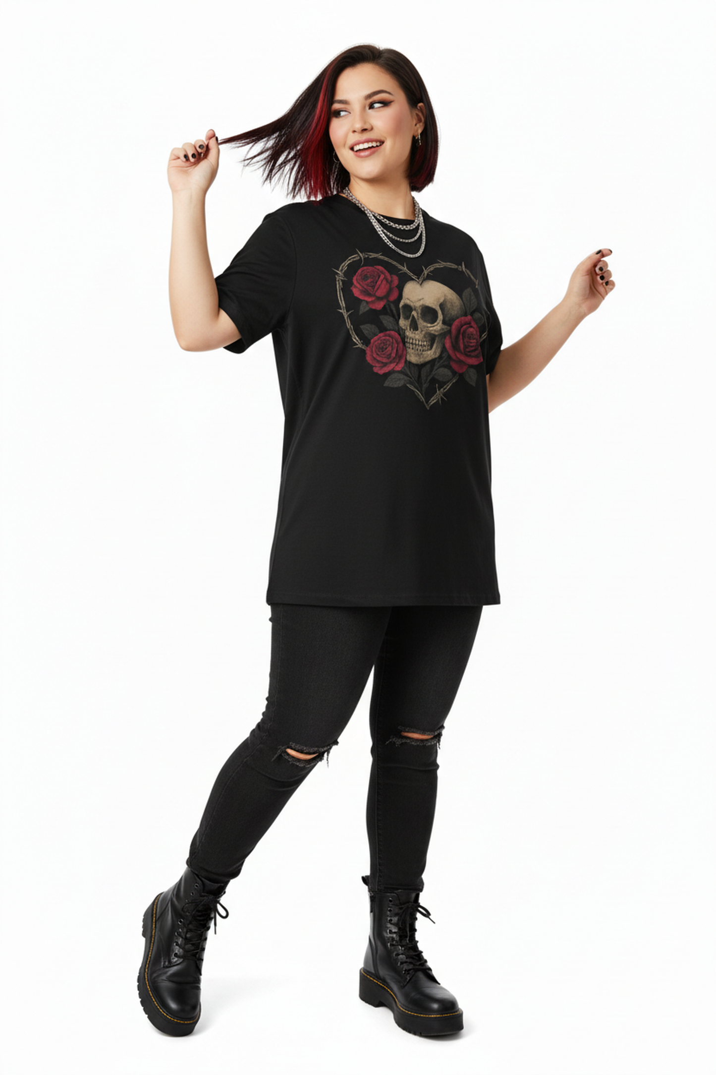 Woman wearing a black t-shirt with a skull and roses design, black leggings, and black boots on a white background.