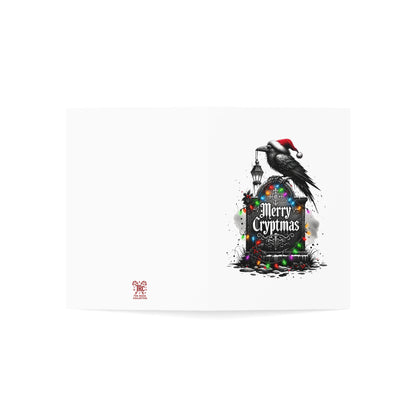 Greeting card with a black cat wearing a Santa hat on a tombstone with 'Merry Cryptmas' text, surrounded by colorful lights.