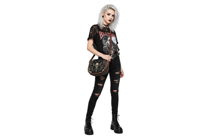 Person wearing a black outfit with graphic designs on a white background