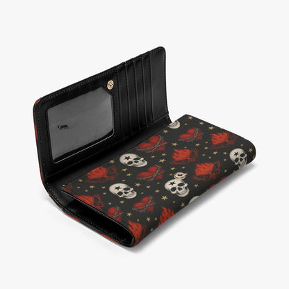Open clutch wallet showing card slots and clear ID window with skull and cherry print exterior.