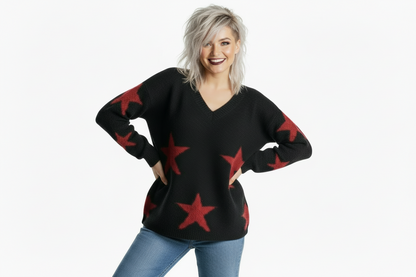 Woman wearing a black sweater with red star patterns on a white background