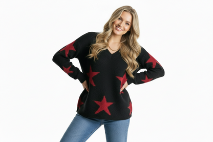 Woman wearing a black sweater with red star patterns on a white background